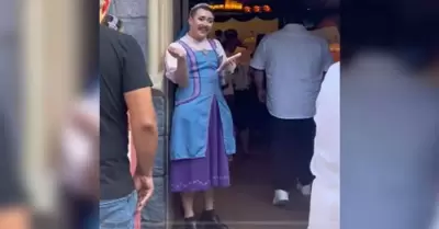 Un empleado, vestido de mujer y con maquillaje, da la bienvenida a la boutique B