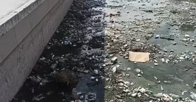 A pesar de avisos de lluvia, ciudadana persiste en tirar basura que tapa canale